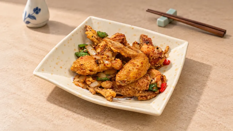 Pho 99 fried chicken wings tossed in spicy salt with peppers and onions