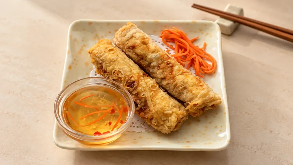 Golden fried pork spring rolls with dipping sauce at Pho 99